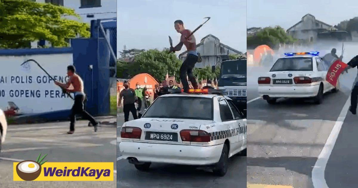 Man runs amok, swinging a parang on top of a police car