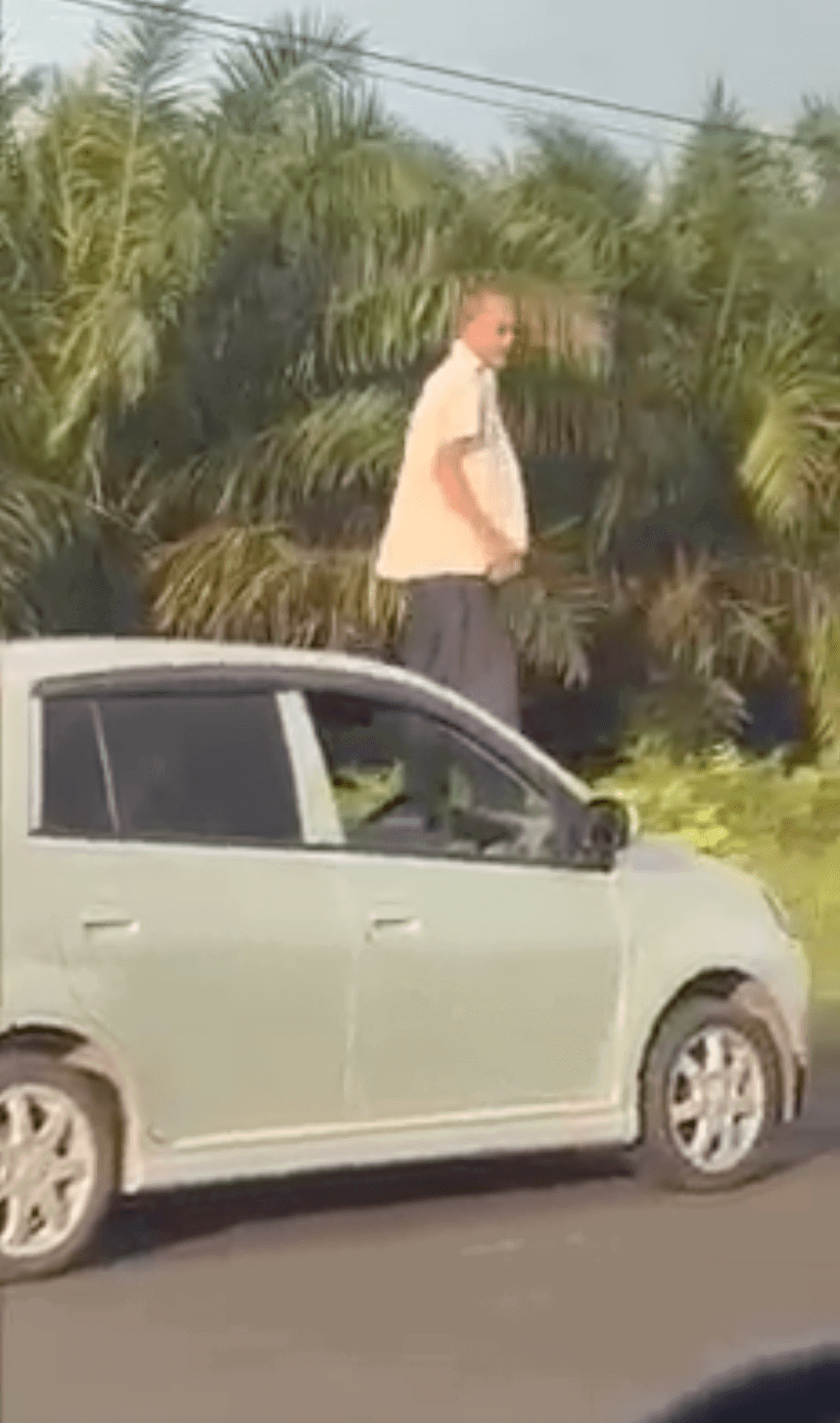 Uncle stuck in heavy raya traffic climbs onto car bonnet and checks the road with binoculars 02-min