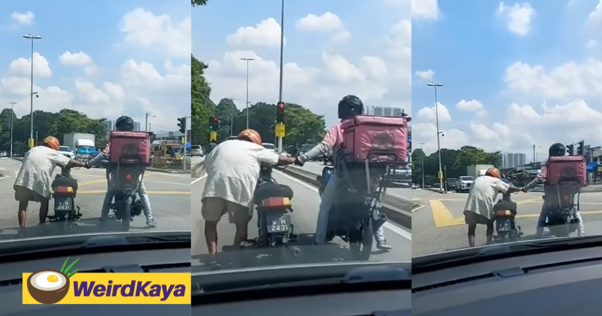 Kindhearted Foodpanda rider helps elderly man push his motorbike under the hot sun