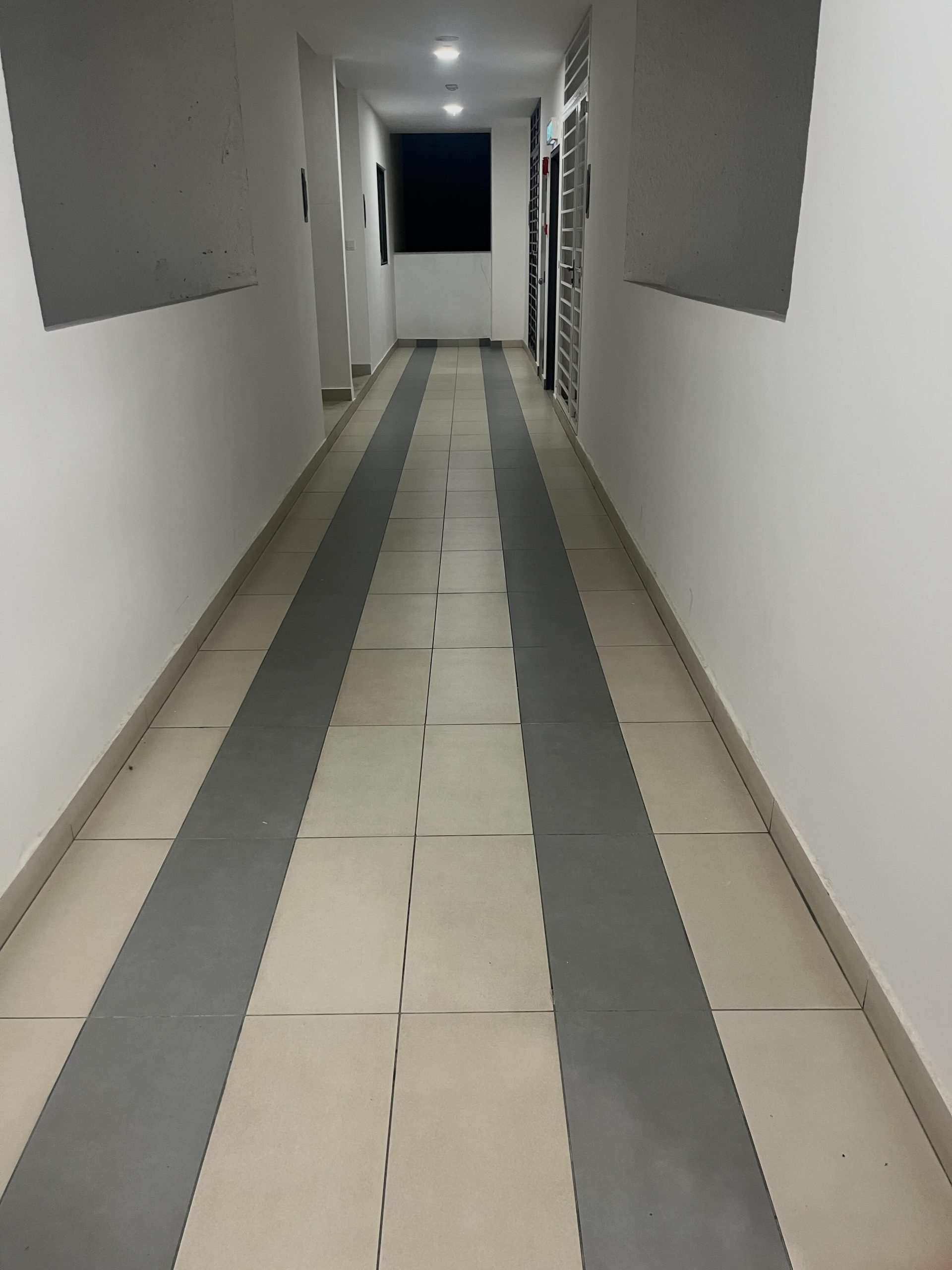 Woman mops apartment corridor (1)