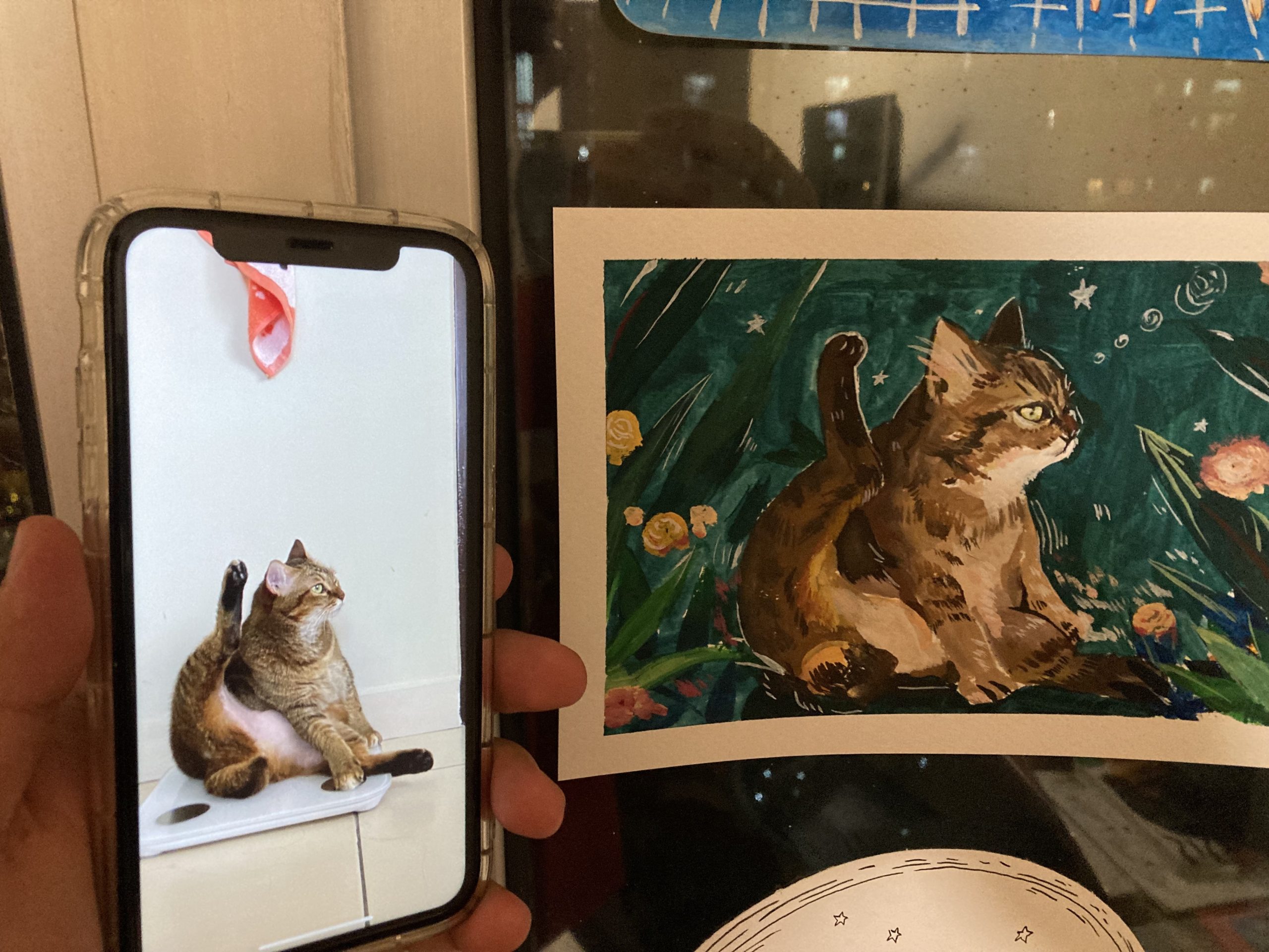 Yasmeen's cat paintings with a real life reference of her own cat, mao.