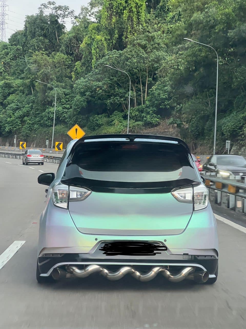 A car on road with spiral exhaust pipe