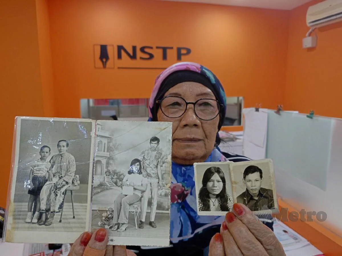 A malaysian mother showing photograph of her children