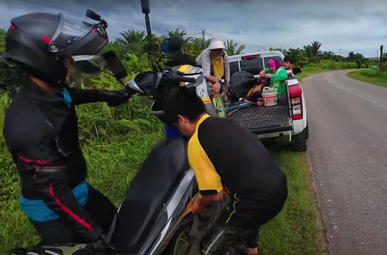 Abang carrying the motorcycle