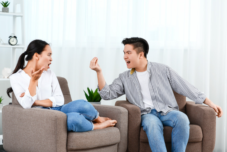 Asian couple fighting in the living room