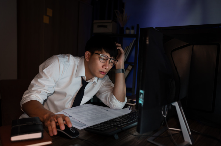 Asian man getting stressed at work