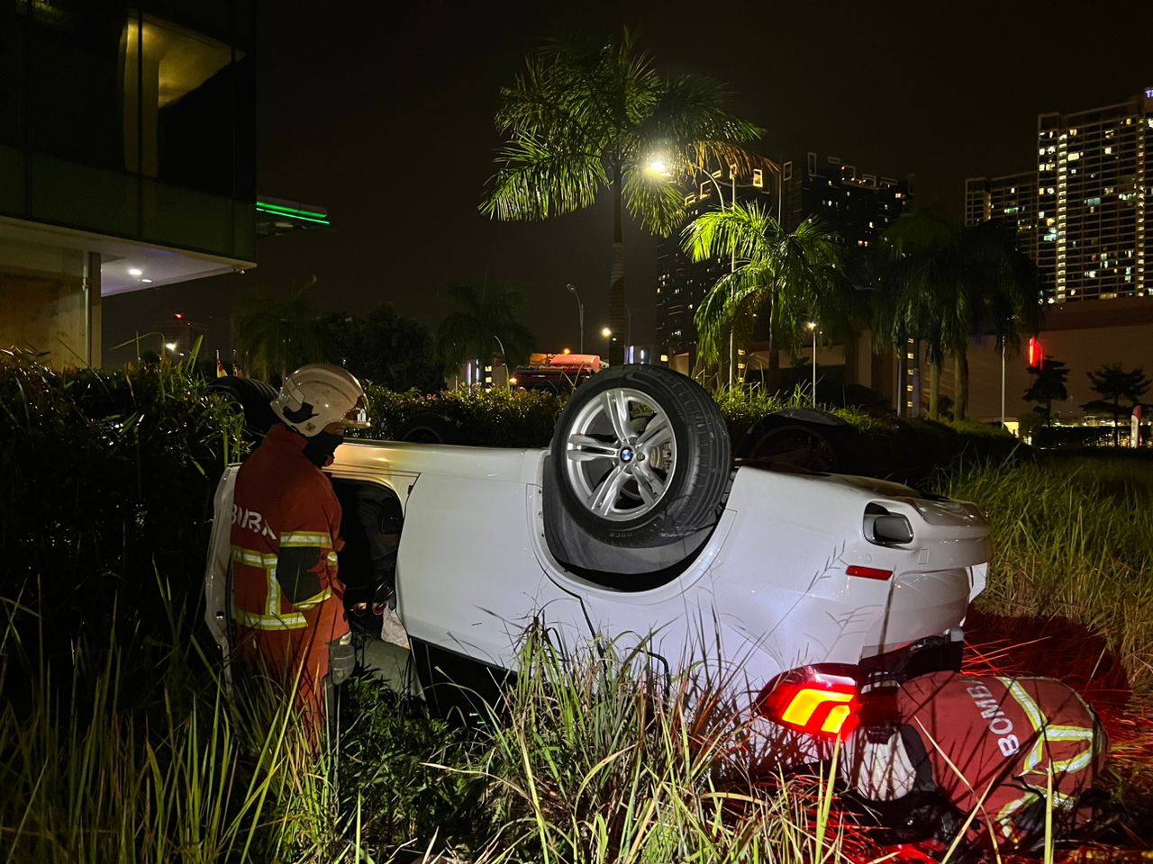 Bmw falls at grassy area after falling off 2nd floor