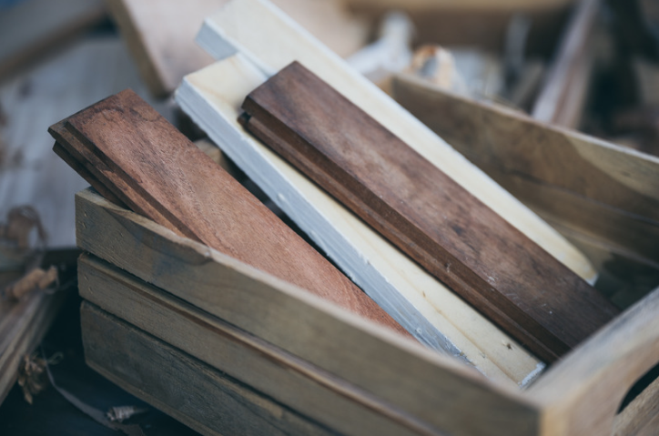 Box filled with wooden pieces