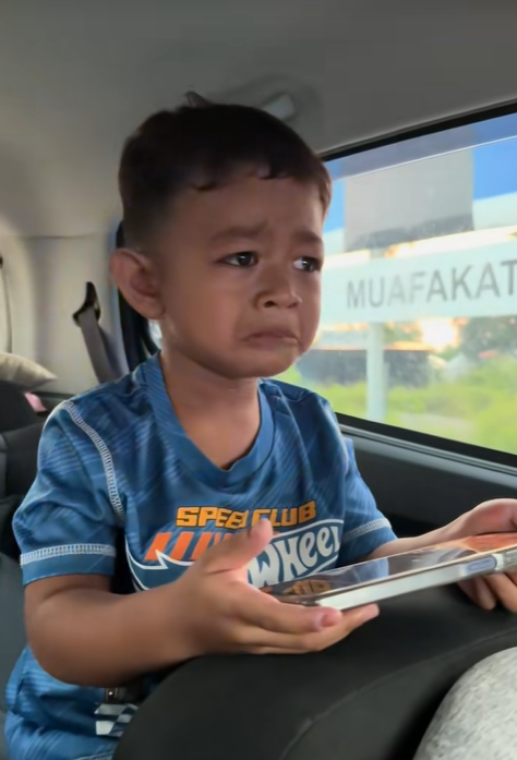 Boy crying when escort police stop them