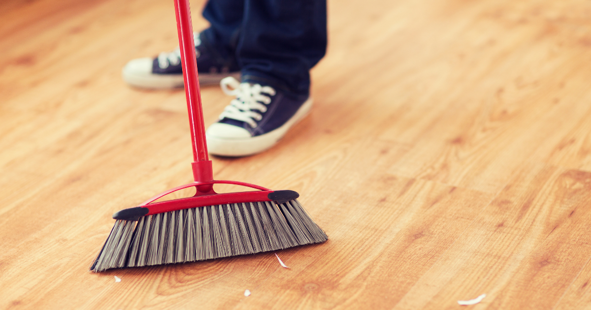 Boy sweeping the floor