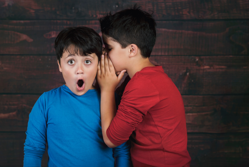 Boy whispering to his friend