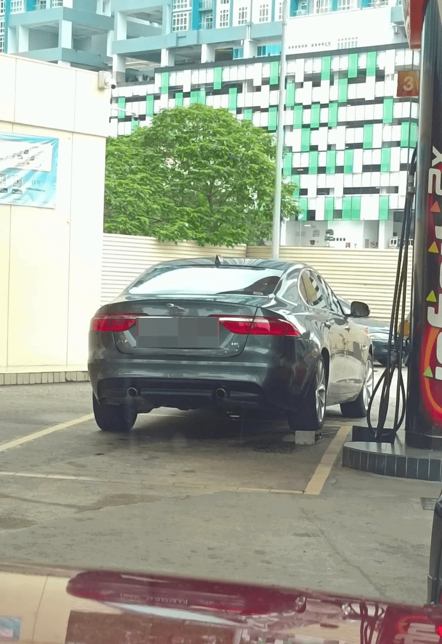 Jaguar with a brick underneath its right rear wheel