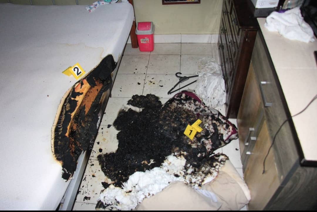 Burned mattress and pillow in a room