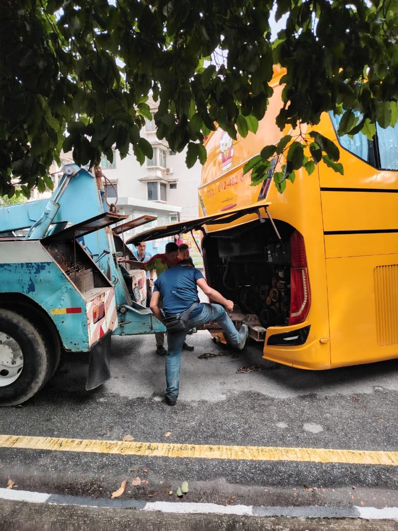 Bus being towed out from sinkhole in penang