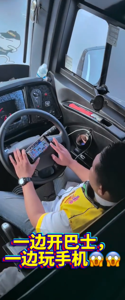 Bus driver playing game while on the road