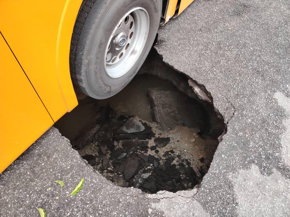 Bus wheel stuck inside sinkhole in penang