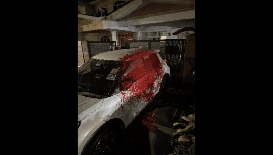 Car splashed with red paint