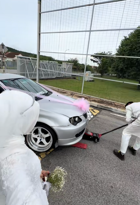 Car stuck at road bump during wedding