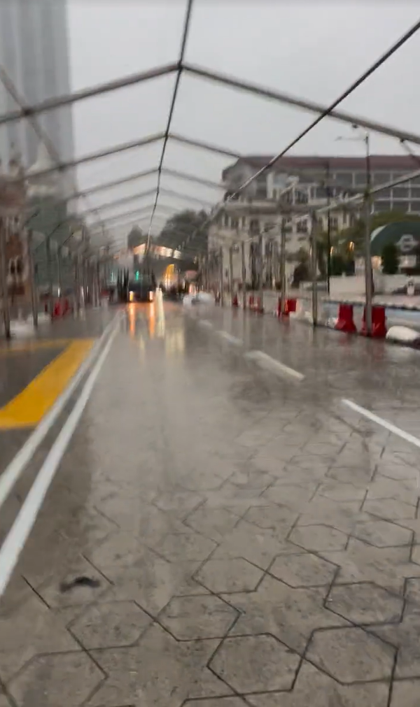 China tourist running in the rain near merdeka square