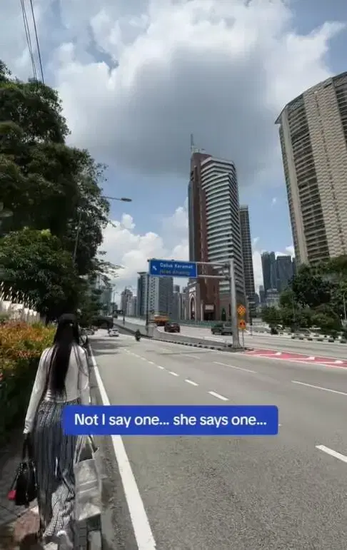 China tourist walking along the road in KL