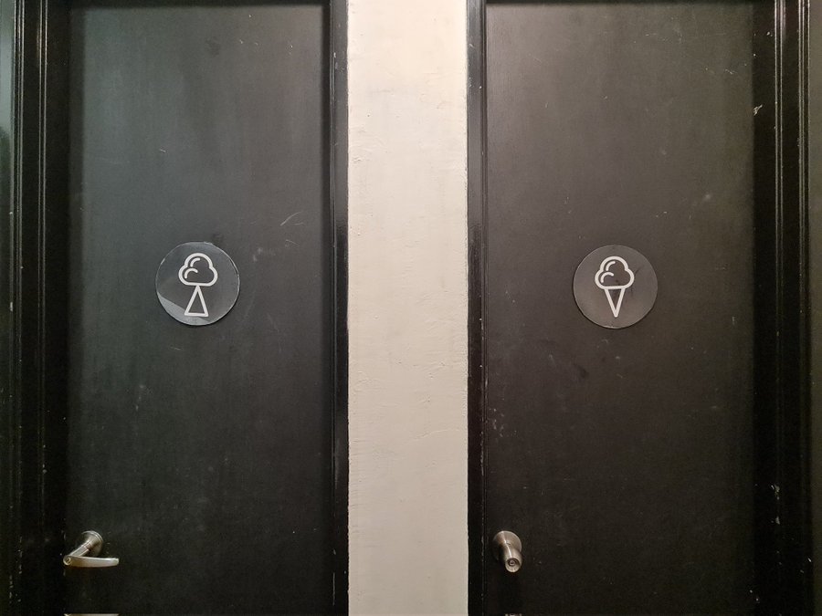 Confusing toilet sign featuring a cloud and triangle