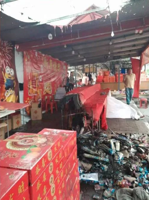 Stall selling firecrackers and mandarin oranges damaged by fire