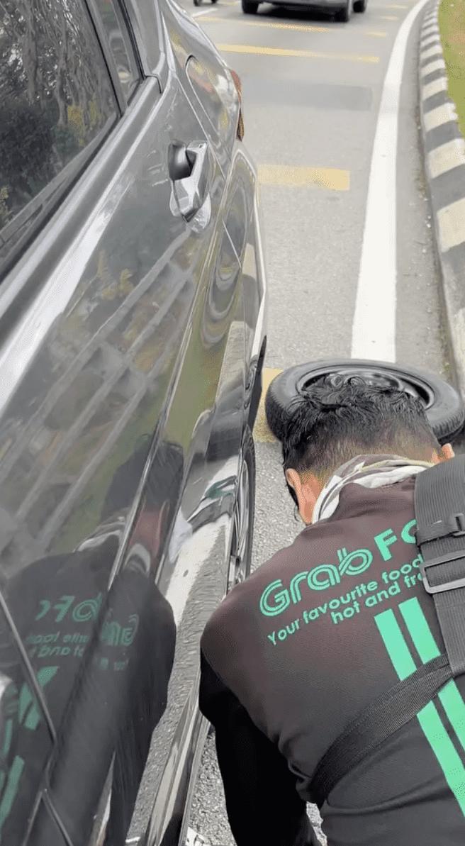 Delivery rider changing tyre