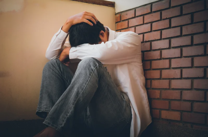 Depressed young man hiding his face