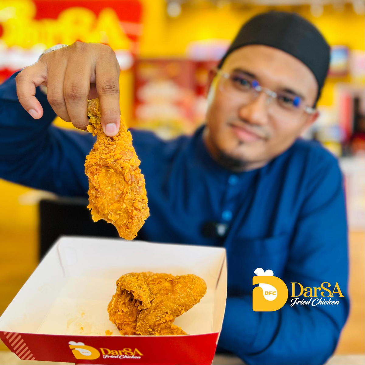 DFC founder holding fried chicken