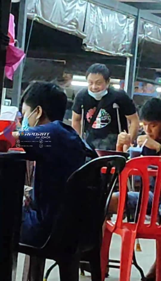 Disabled beggar walking inside a restaurant in jb