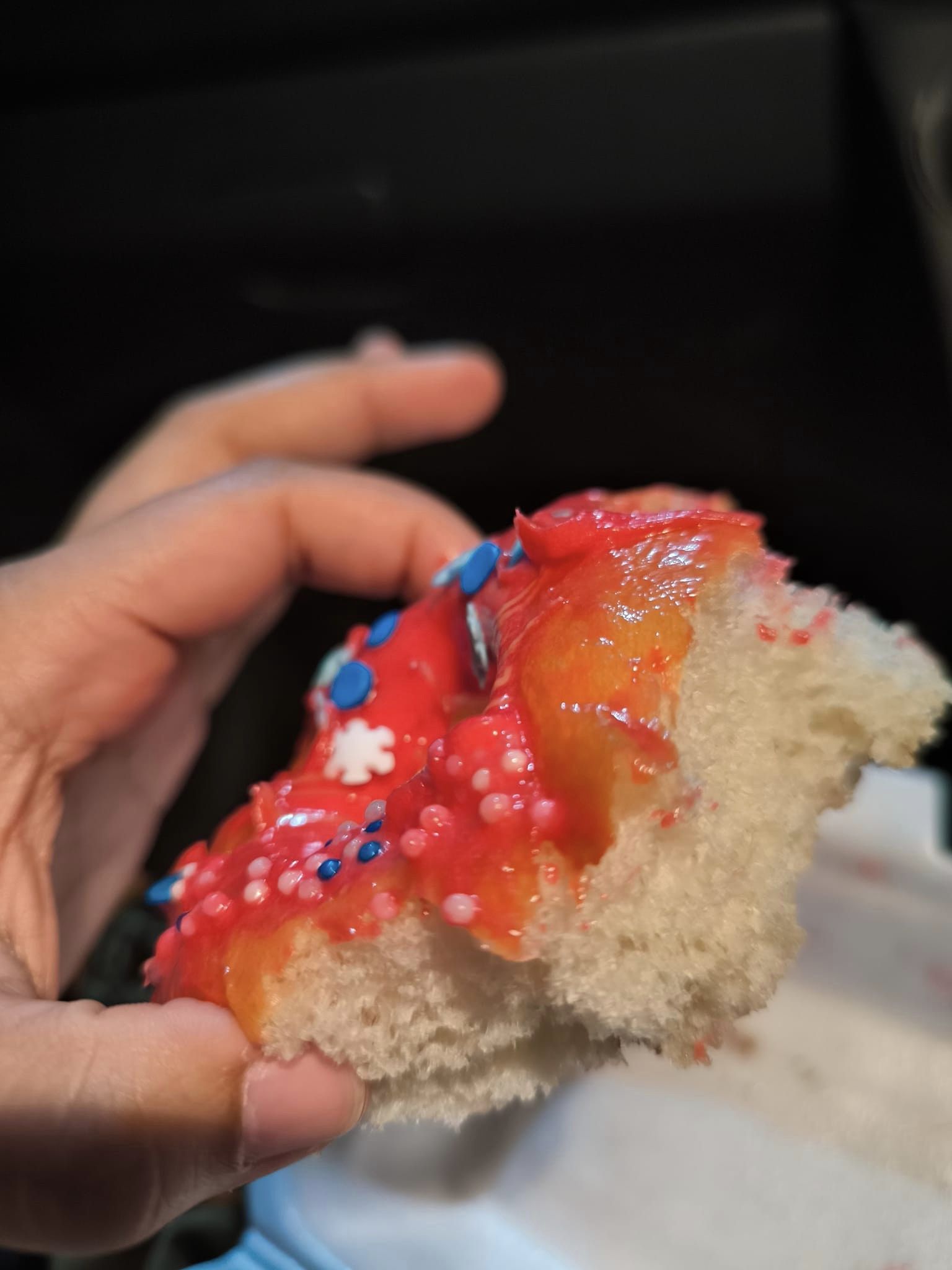 Close up photo of donut which is actually burger bun with a hole