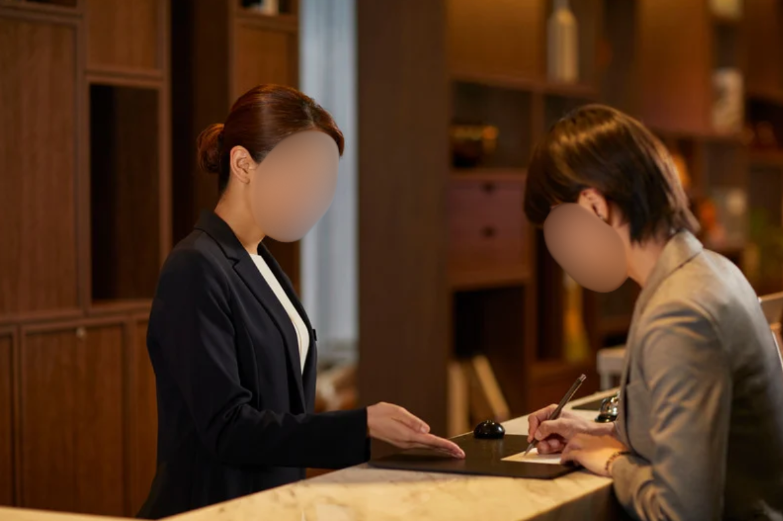Female receptionist at hotel front desk