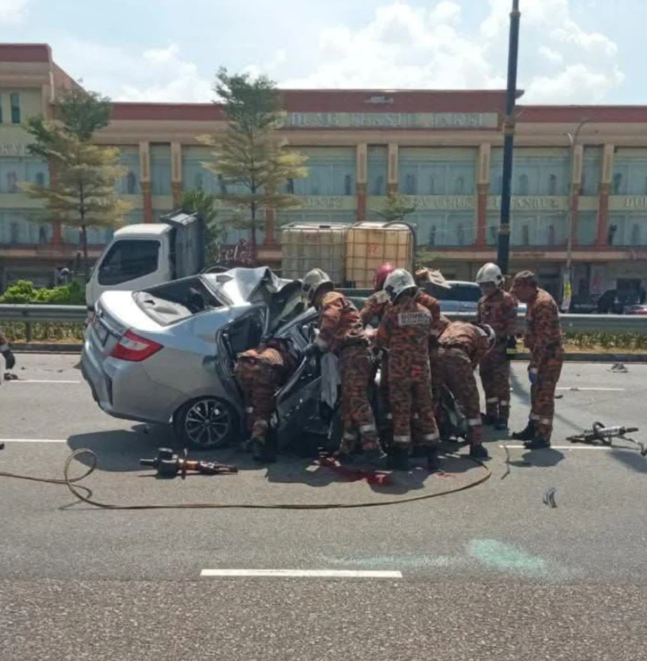 Firefighters inspecting wrecked car in JB crash