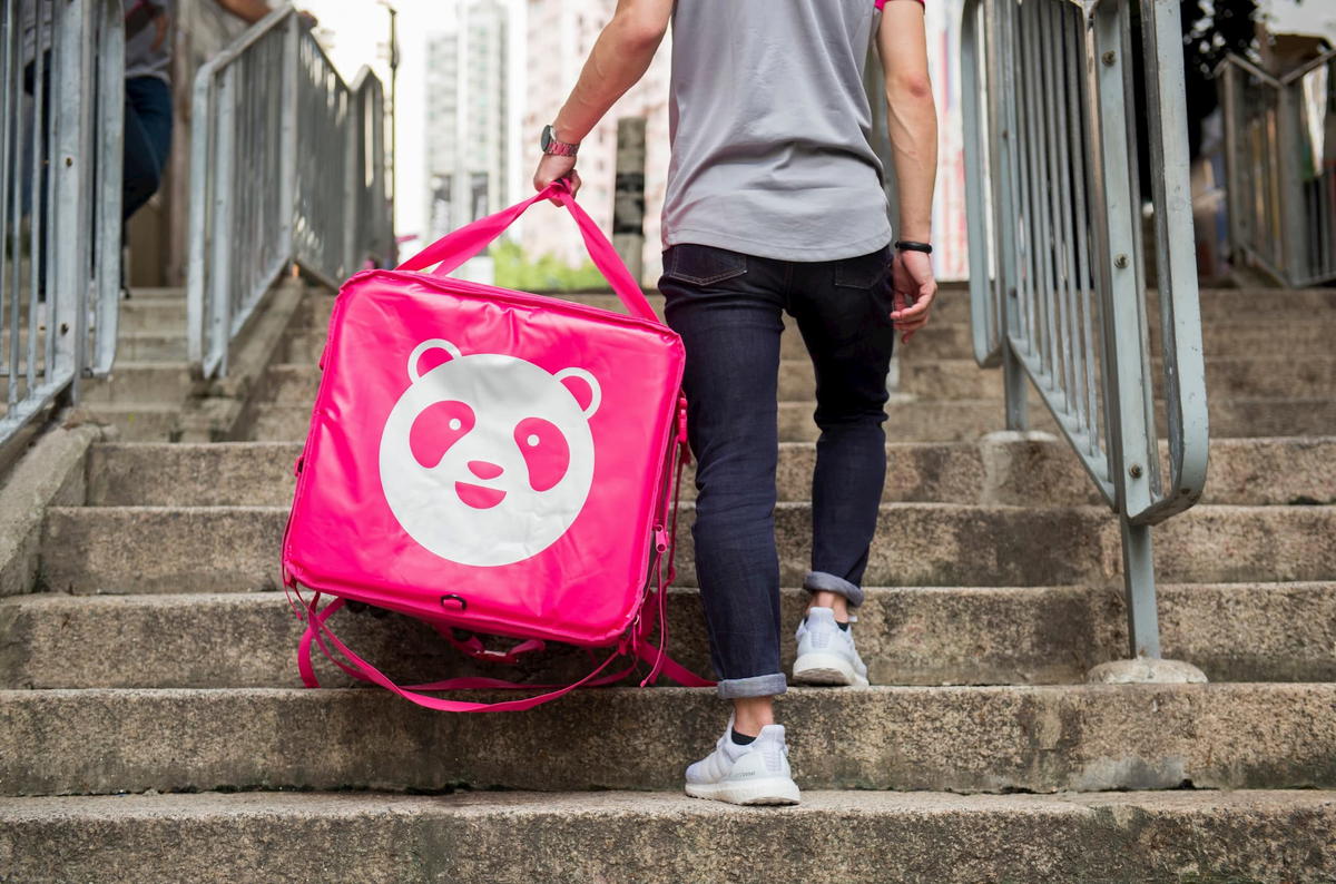 Foodpanda deliveryman walking up the stairs