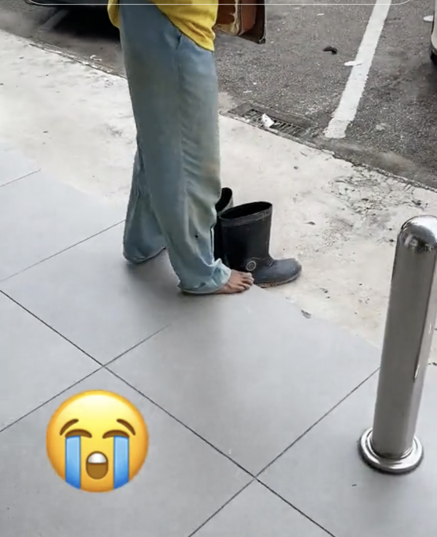 Foreign worker removes shoes at atm 03