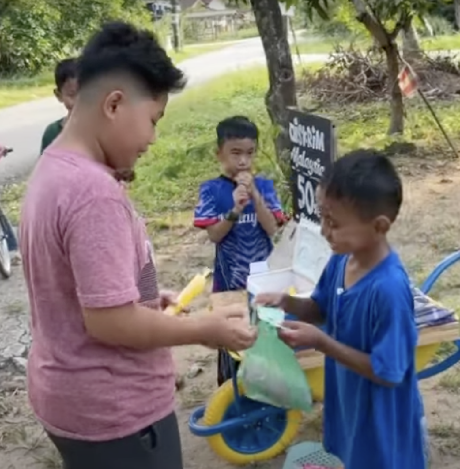 Friend buying ice pop from 7yo boy