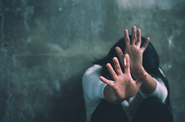 Frightened woman covering her face