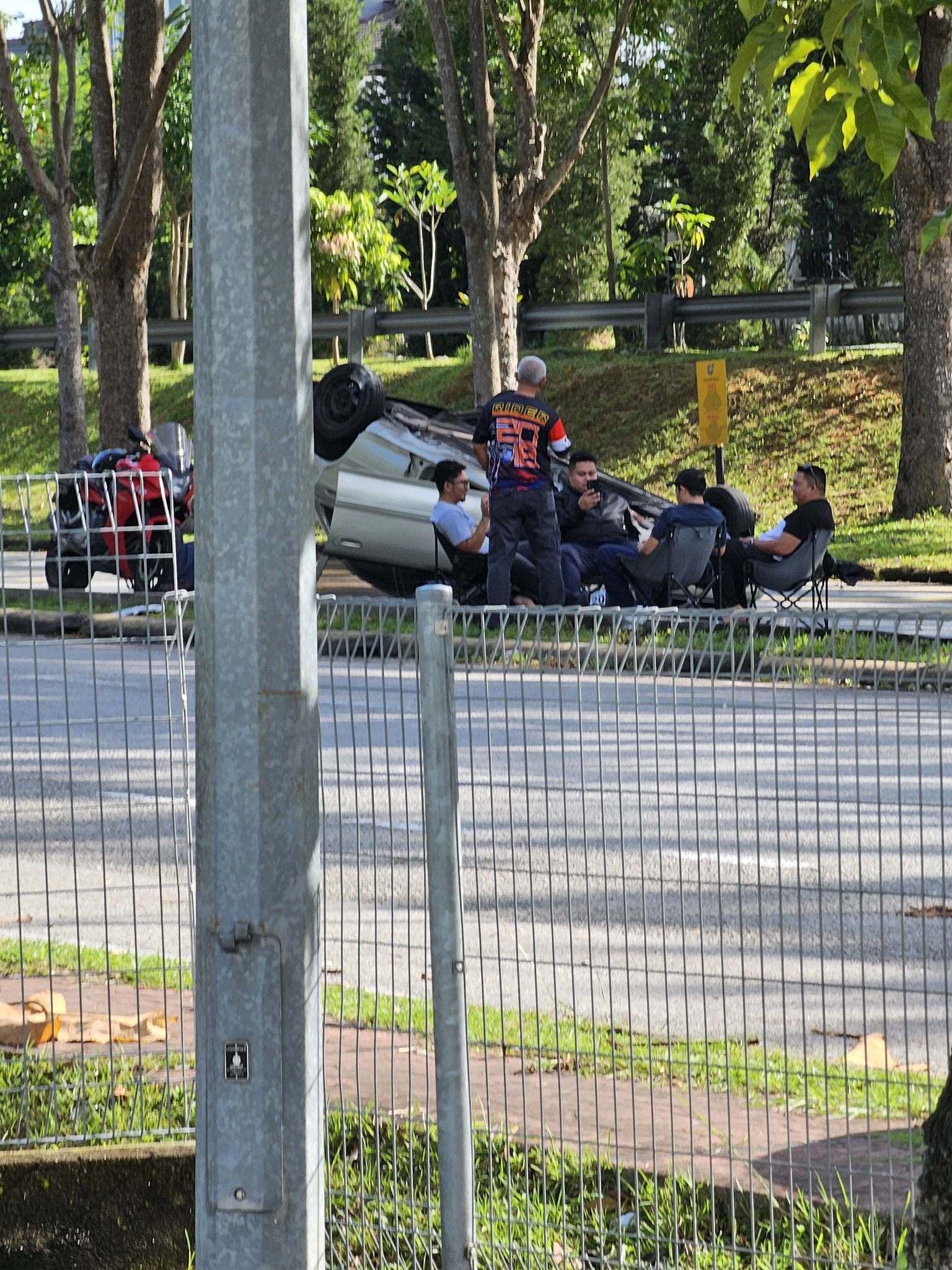 Group of m'sians seen chilling by the roadside after their car flipped while trying to avoid a dog | weirdkaya
