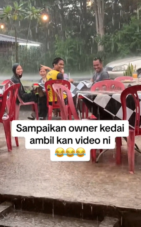 Group of m'sians smile while getting soaked in the rain