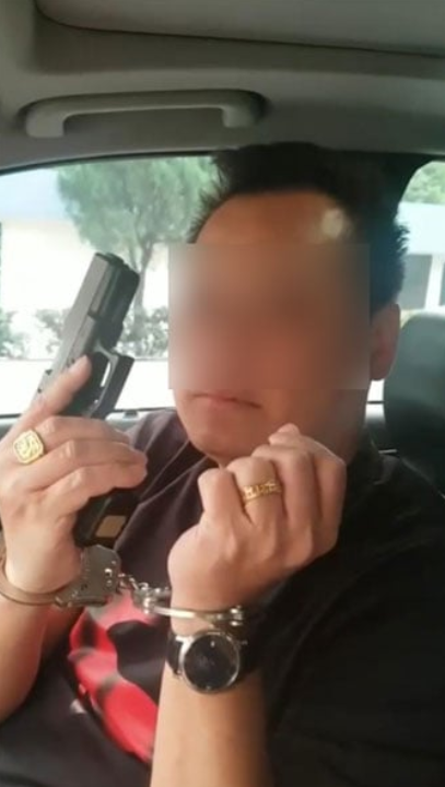M'sian man poses with a gun while handcuffed, now remanded for 4 days by police