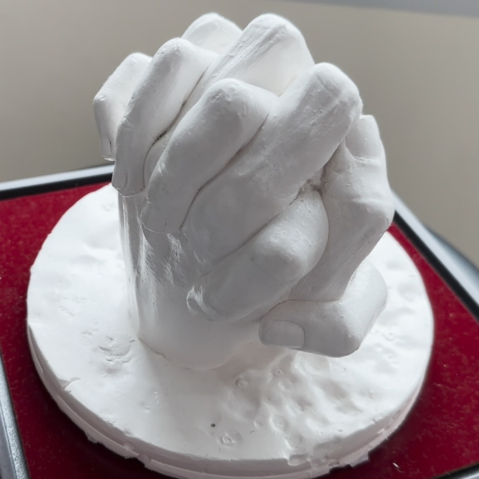 Completed hand cast mould of yiu holding his wife's hand