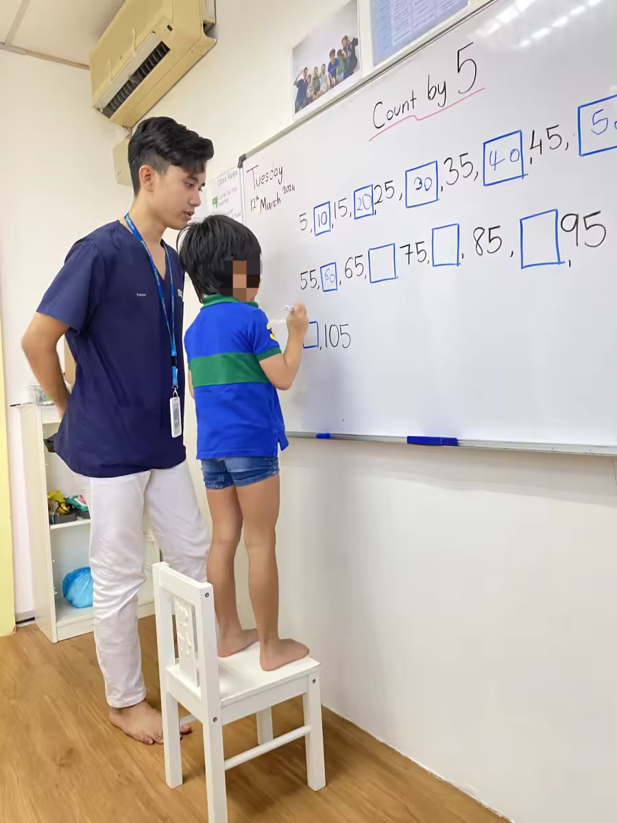 Haqim does math with kid