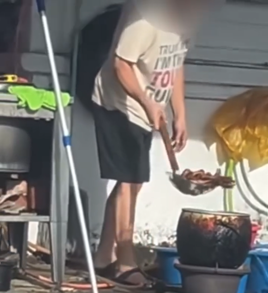 Hawker transfers chicken feet to metal pot