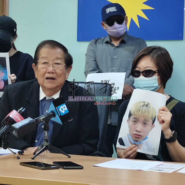 Huang holds photo of disowned son