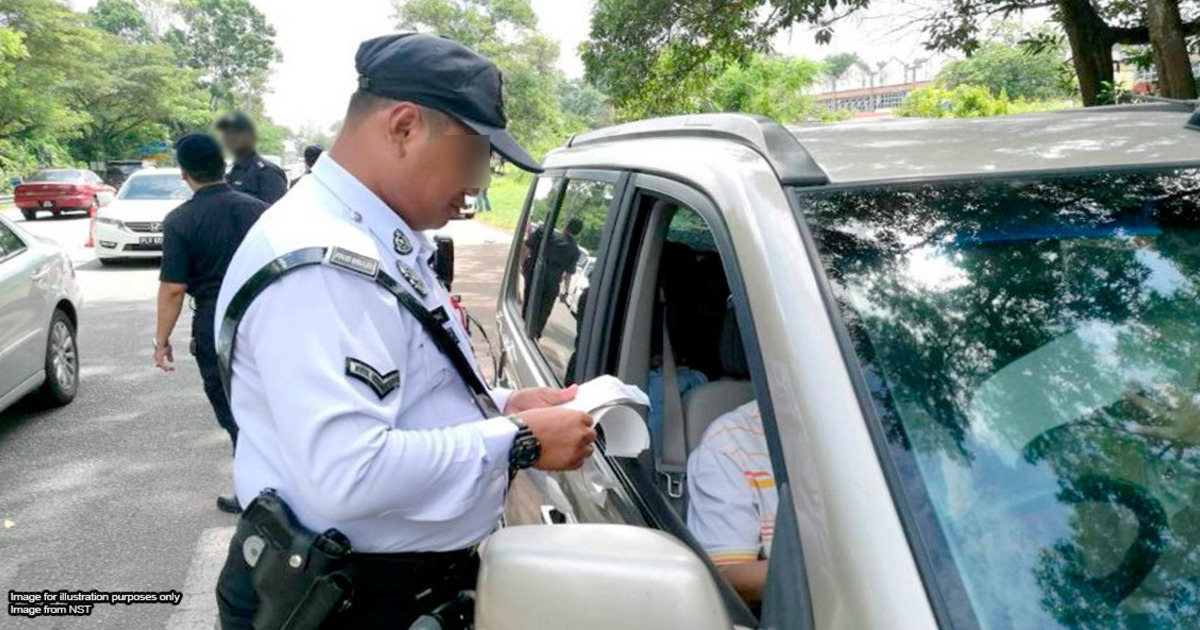 Police officer giving out saman