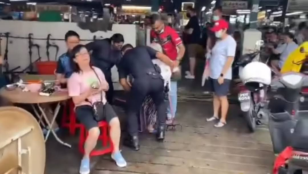 Kindly police officer lifts up senior woman  across the road and pays for her meal