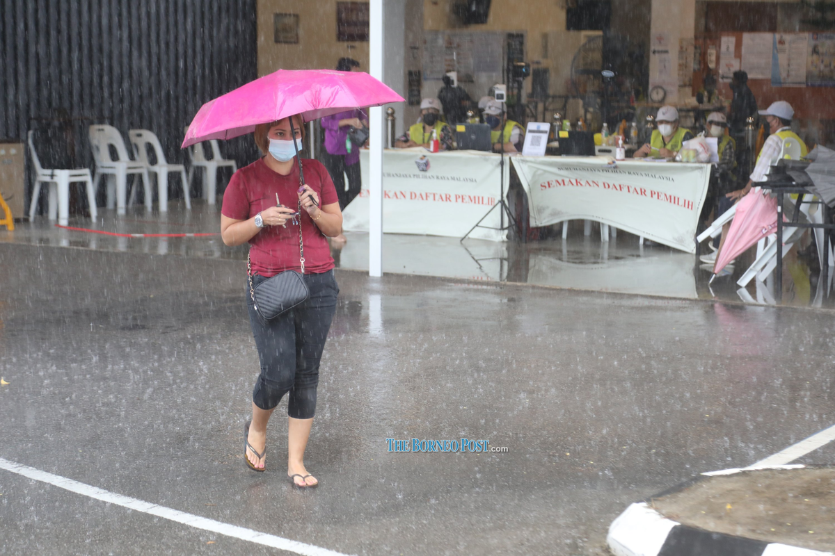 Voter walking in the rain