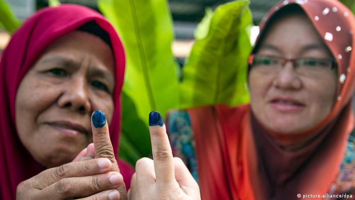 Malay voters with inked fingers