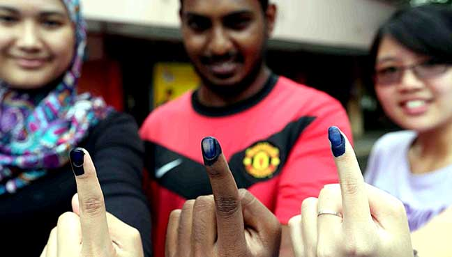 Malaysian voters showing inked fingers