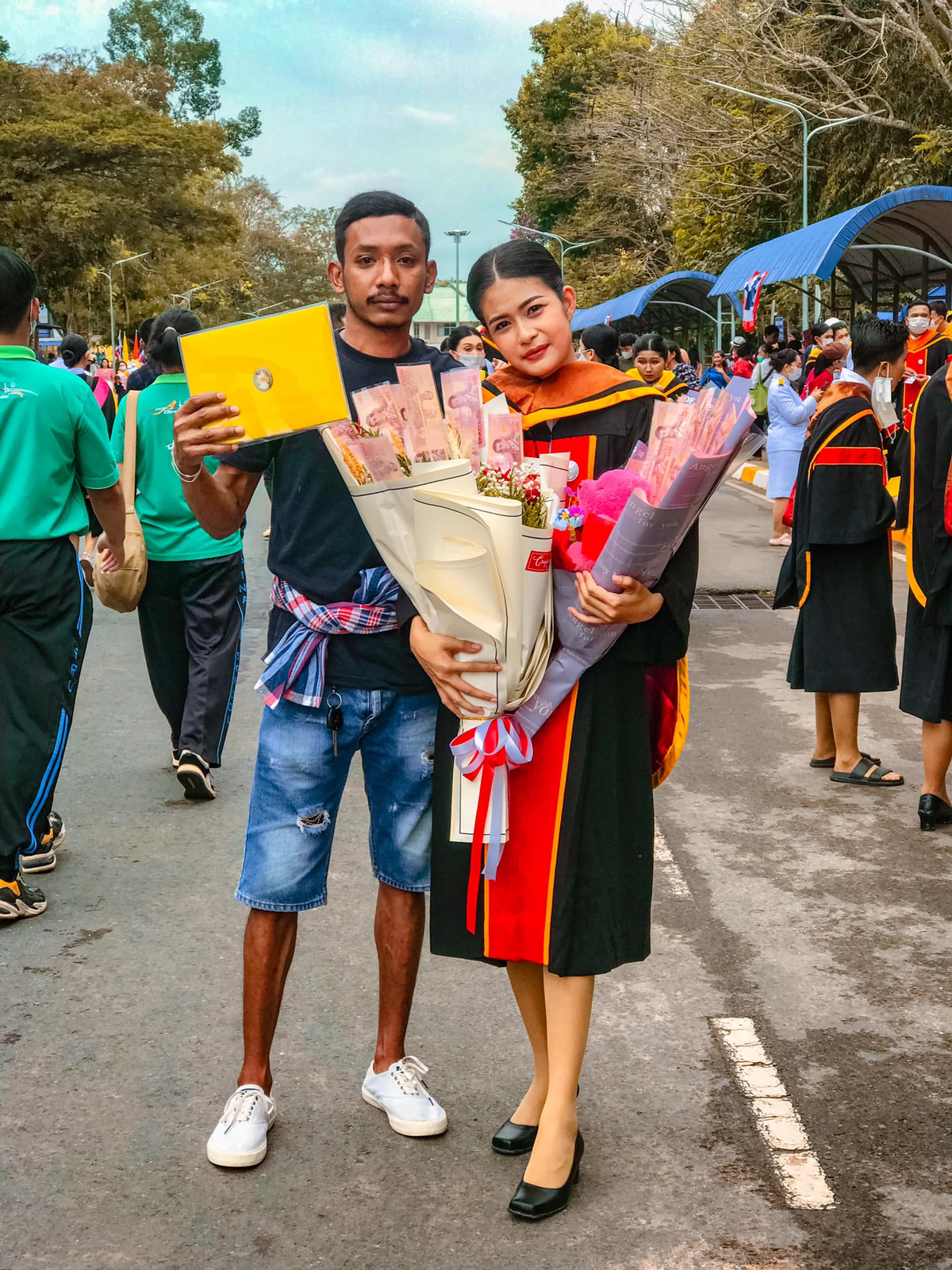 Thai woman bows before her brother's feet to thank him for giving up his education for hers